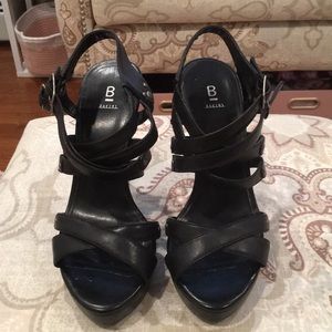 Black leather platform sandals w/silver buckles.